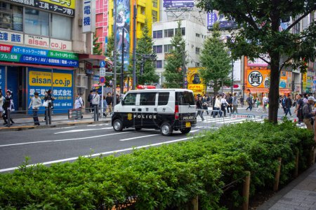 Photo for Tokyo, Japan, November 5 2023: Police van patrolling a busy street - Royalty Free Image