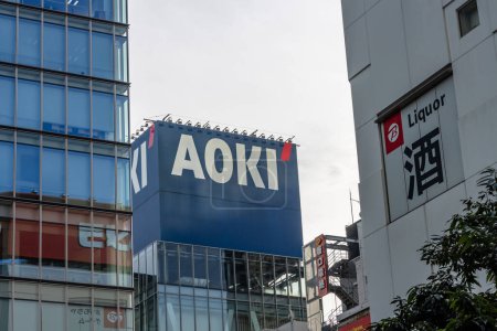 Photo for Tokyo, Japan, November 6 2023: Urban landscape with AOKI fashion store and LIQUOR signage - Royalty Free Image