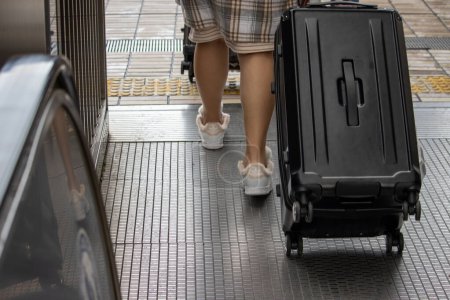 Photo for Tokyo, Japan, November 6, 2023: Close-up of Pedestrian with Suitcase - Royalty Free Image