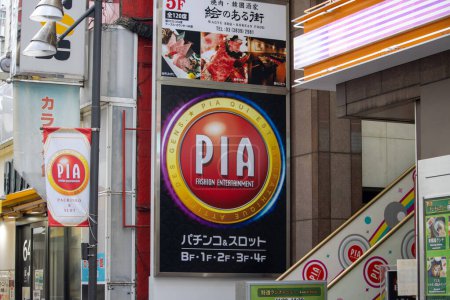 Photo for Tokyo, Japan, 6 November 2024: Colorful Street Scene with PIA Pachinko and Slot Parlor Signage - Royalty Free Image