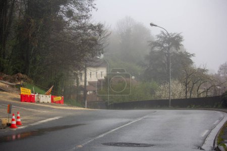 Photo for France, 30 March 2024: Foggy Day with Roadblock on Suburban Street - Royalty Free Image