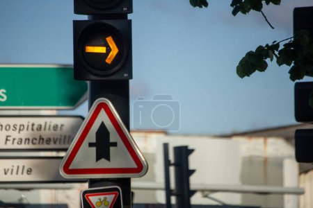 Photo for France, 11 April 2024: Traffic Light and Direction Indicator on Urban Street - Royalty Free Image