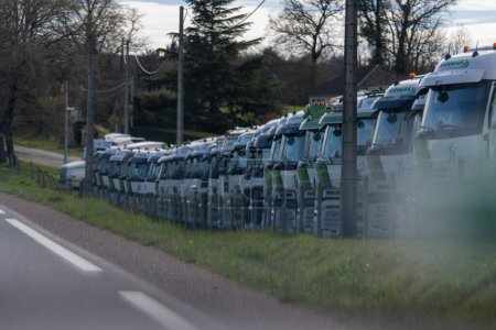 Photo for France, 30 March 2024: Garbage trucks lined up on a roadside in France, showcasing urban municipal services - Royalty Free Image