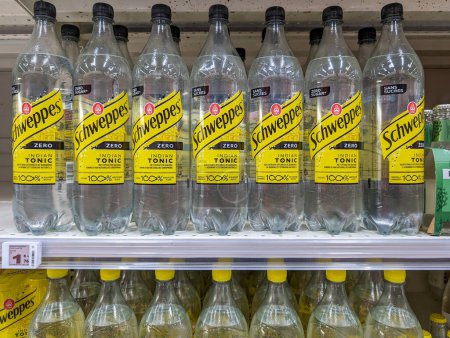 Téléchargez les photos : France, 26 Avril, 2024 : Les rangées de bouteilles d'eau tonique indienne Schweppes affichées sur les étagères des supermarchés - en image libre de droit