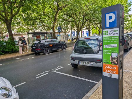 Téléchargez les photos : France, 5 mai 2024 : Rue urbaine avec compteur de stationnement par téléphone - en image libre de droit