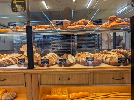 Téléchargez les photos : France, 8 mai 2024 : Variété de pains fraîchement cuits dans une boulangerie - en image libre de droit