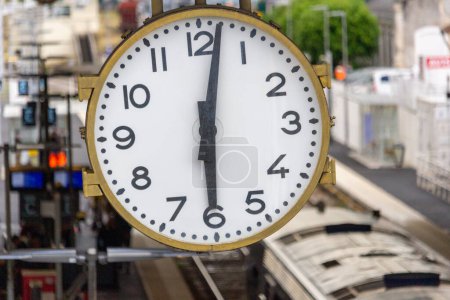Photo for France, 22, May, 2024: Railway station clock showing time 12:05 in a busy urban setting - Royalty Free Image