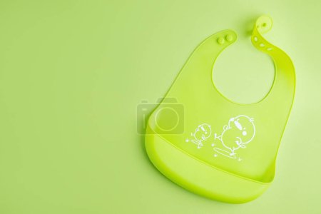 Photo for Baby porridge with cutlery on green background. Baby food concept. - Royalty Free Image