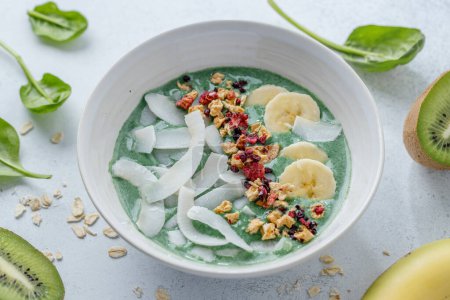 Photo for Green smoothie bowl with topping and fruits. Closeup - Royalty Free Image