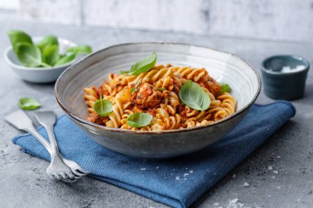 Photo for Pasta with tomato sauce chicken and basil served in bowl. Closeup - Royalty Free Image