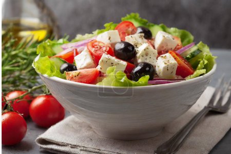 Photo for Tasty greek salad with vegetables and feta served in bowl. - Royalty Free Image