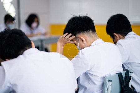 Téléchargez les photos : Blurred close up student study stress  in class at school. Education concept. - en image libre de droit
