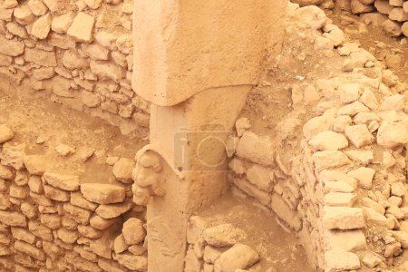 Pillar 27 in Enclosure C at the neolithic archaeological site of Gobekli Tepe, Potbelly Hill, showing a predator or cat on a t-shaped pillar hunting a boar, close to Sanliurfa, Turkey 2022