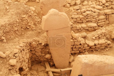 Pillar 2 in Enclosure A at the neolithic archaeological site of Gobekli Tepe, Potbelly Hill, a t-shaped pillar showing an auroch, a fox and a crane, close to Sanliurfa, Turkey 2022