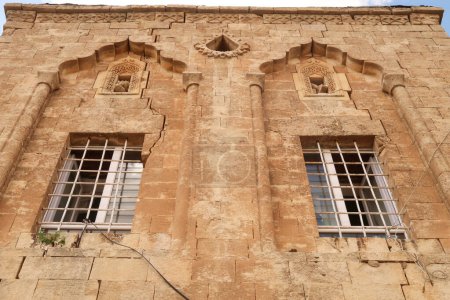Téléchargez les photos : Deux fenêtres sur la façade d'une maison traditionnelle dans la vieille ville de Mardin, décorée avec des motifs et des détails sculptés élaborés, Mardin, Turquie 2022 - en image libre de droit
