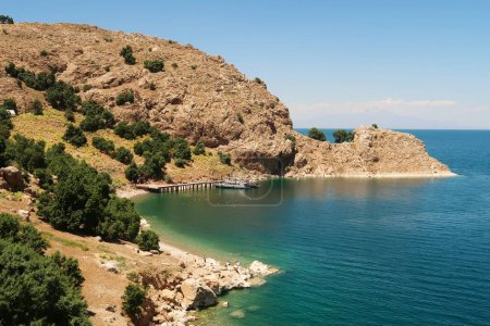View onto the little pier, jetty on Akdamar Island on Lake Van, Van Golu surrounded by a bay with intense blue, green, turquoise water, Van, Turkey 2022