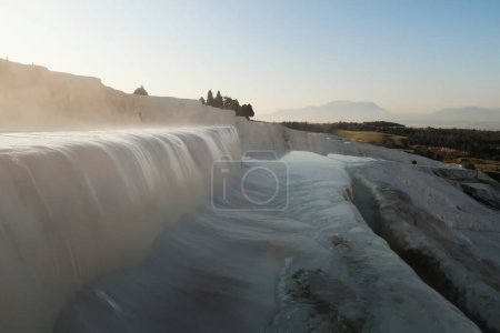 Steaming water running over a travertine terrace at Pamukkale in the early morning, Denizli, Turkey 2022