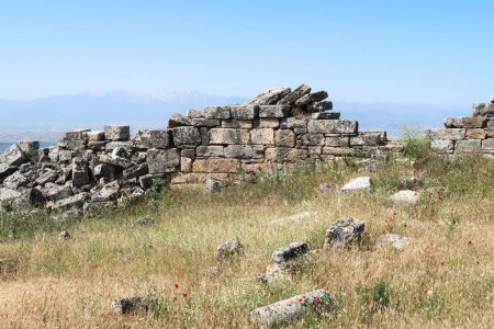 Ruins of the town wall of the archaeological site of Hierapolis with mountains in the background, Pamukkale, Denizli, Turkey 2022