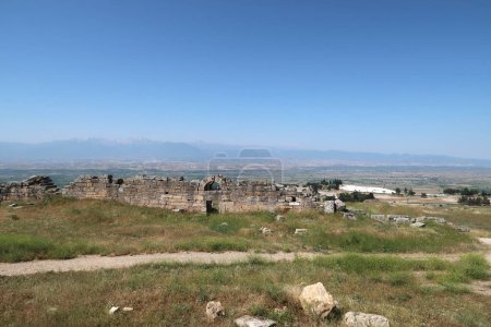 The town wall of the ancient site of Hierapolis with Pamukkale, the valley and the mountains in the background, Denizli, Turkey 2022