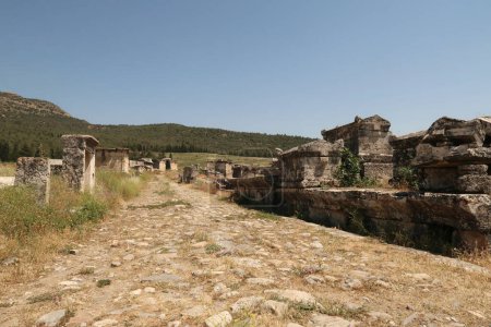 Hauptstraße, die durch die nördliche Nekropole an der antiken Stätte von Hierapolis führt, gesäumt von Sarkophagen und Gräbern, Pamukkale, Denizli, Türkei 2022