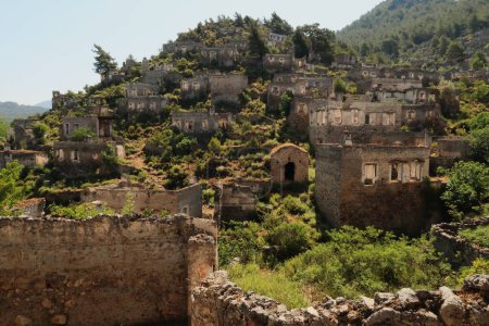 Ruins of houses on a hill in the abandoned village of Kayakoy, Livissi, close to Fethiye, Turkey 2022
