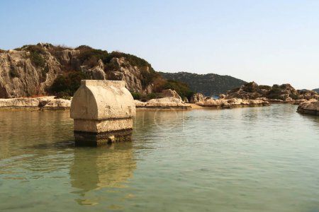 Sarcophagus standing in the shallow water close to the harbor of Kalekoy, close to Demre, Turkey 2022