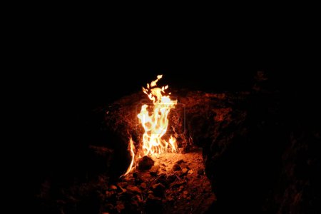 One of the eternal flames burning at Mount Chimaera at night, close to Antalya, Turkey 2022