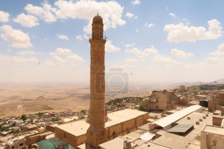 View onto the landscape of Syria from the old town of Mardin, with the minaret of the Great, Grand Mosque, Ulu Camii in the foreground, Mardin, Turkey 2022