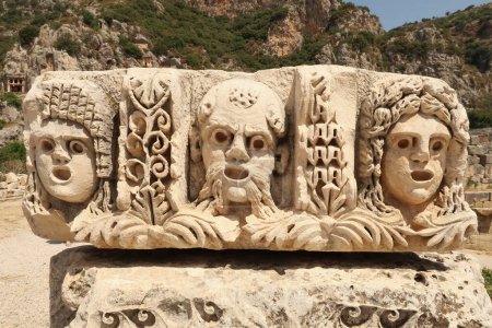 Stein mit antiken Reliefs von drei Theatermasken in der antiken Stadt Myra, in der Nähe von Demre, Türkei 2022