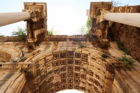The ceiling of one of the entry arches of the Hadrians Gate sided by two roman columns, Antalya, Turkey 2022