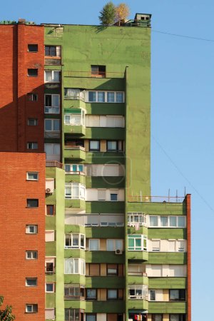 A colorful, orange and green socialist, brutalist concrete panel, multi-story, high-rise, apartment block, building in the city center of Prishtina, Pristina, Kosovo 2022