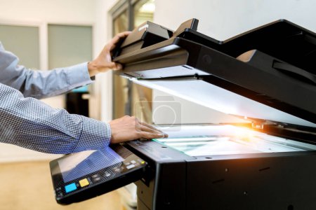 Photo for Business man Hand press button on panel of printer, printer scanner laser office copy machine supplies start - Royalty Free Image