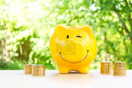Photo for Happy piggy bank on wooden floor. - Royalty Free Image