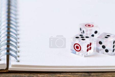Photo for Tree dice on white book. - Royalty Free Image