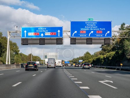 Photo for UTRECHT, NETHERLANDS - OCT 15, 2021: Traffic and route information on overhead gantry, orbital motorway A27 at exit to A28 - Royalty Free Image