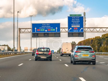 Photo for UTRECHT, NETHERLANDS - OCT 15, 2021: Cars and route information on overhead gantry, motorway A2 at exit to A12, traffic junction Oudenrijn - Royalty Free Image