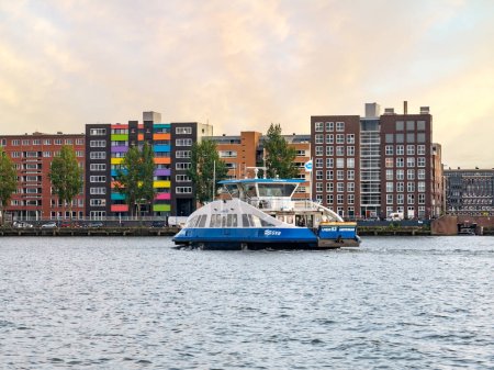 Photo for AMSTERDAM, NETHERLANDS - AUG 20, 2021: Ferry boat and apartment buildings on Java Island in Eastern Docklands - Royalty Free Image