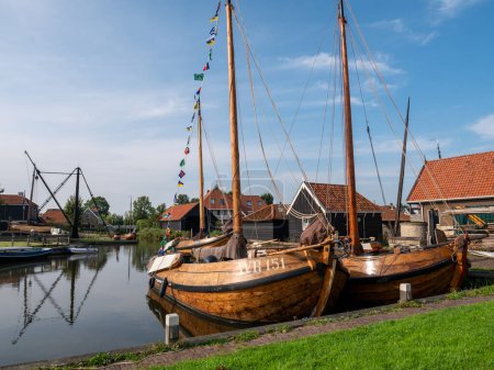 Photo for WORKUM, NETHERLANDS - SEP 14, 2021: Traditional shipyard Scheepstimmerwerf and Diepe Dolte canal in historic town of Workum, Friesland - Royalty Free Image