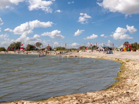 Photo for MAKKUM, NETHERLANDS - AUG 12, 2023: People enjoying the beach of IJsselmeer lake in Makkum, Friesland, Netherlands - Royalty Free Image