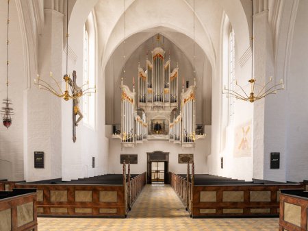 Photo for Mariager, Denmark - Sep 20, 2023: Interior of Mariager Parish Church with organist playing the aubertin pipe organ, Nordjylland, Denmark - Royalty Free Image