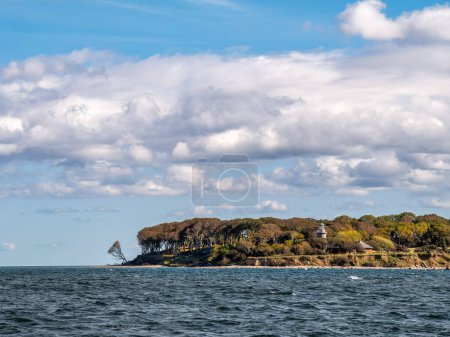 Coastline of northern area of Aebelo Island with lighthouse on bluff in Kattegat north of Funen, Syddanmark, Denmark