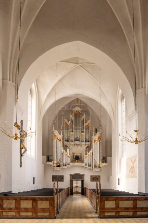 Photo for Mariager, Denmark - Sep 20, 2023: Interior of Mariager Parish Church with organist playing the aubertin pipe organ, Nordjylland - Royalty Free Image