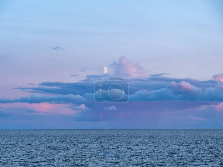 Foto de Primer cuarto de luna y nubes de lluvia al atardecer sobre Kattegat desde la isla de Tuno, Midtjylland, Dinamarca - Imagen libre de derechos