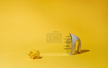 Foto de Iron with nails on yellow background. Modern devices and retro things. Concept of vintage pop art, mix of times. - Imagen libre de derechos