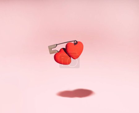 Foto de Creative valentines or romantic concept, two connected hearts on pink background. Minimal love concept. - Imagen libre de derechos