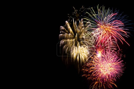 Bright and colorful fireworks on black background. Background for birthday celebrations, big events and parties