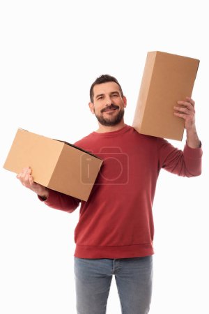 Photo for Man with beard holding large cardboard boxes. Delivery of packages. Home improvements. Organization of personal belongings. White background - Royalty Free Image