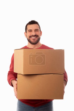 Photo for Bearded man on white background holding large cardboard boxes. Delivery of packages. Home improvements. Organization of personal belongings - Royalty Free Image