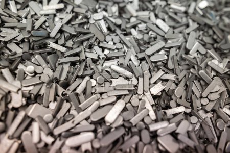 Photo for Metal perforation waste, clippings round and oval shape - technological waste is waste after stamping parts from a sheet or from a strip after laser cutting - Royalty Free Image