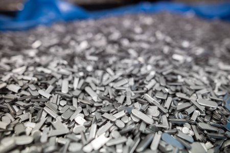Photo for Metal perforation waste, clippings round and oval shape - technological waste is waste after stamping parts from a sheet or from a strip after laser cutting - Royalty Free Image